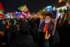Why do Iranians gather in the streets of cities at night?